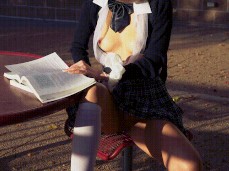 LilyMaeExhib reading with her blouse open at picnic table gif