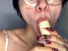 brunette with glasses sucks a banana. gif