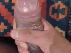 Showing off his cum filled condom and playing with it gif